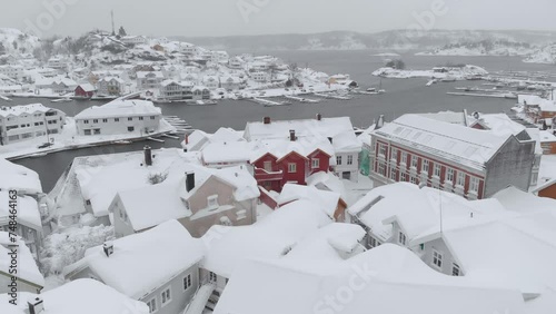 Kragero, Telemark County, Norway - A Charming Town Draped in Snow on a Wintry Day - Aerial Pullback Shot photo