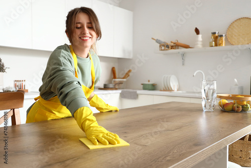 Pretty young woman cleaning...