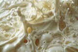 White melted chocolate or sweet cream splash. Boiled tatsy dense liquid close up photo.