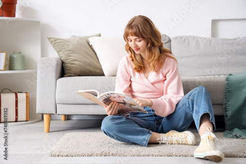 Young woman reading magazin...