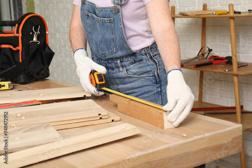 Female carpenter measuring ...