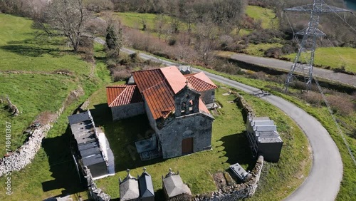 Aerial orbit around Church of Madanela de Cerdeira in San Xoan de Rio, Ourense, Galicia, Spain with graveyard photo