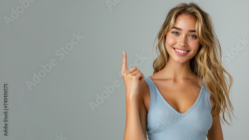 Blonde woman in blue ribbed V-Neck Body, hands in point away pose