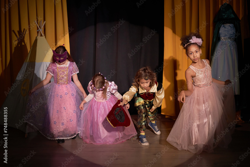 Obraz premium Full length portrait of group of children taking final bow on stage in school play production