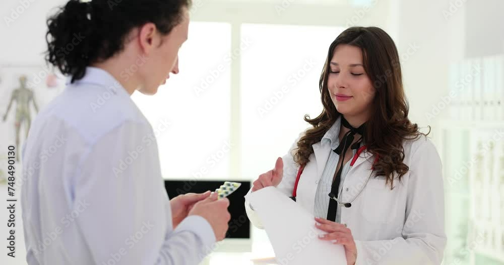 Medicine doctor hands pills and prescriptions to patient Medicine doctor hands pills and prescriptions to patient