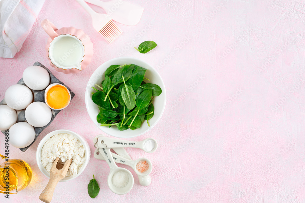 Baking ingredients and kitchen utensils on a pink background, top view Baking ingredients and kitchen utensils on a pink background, top view