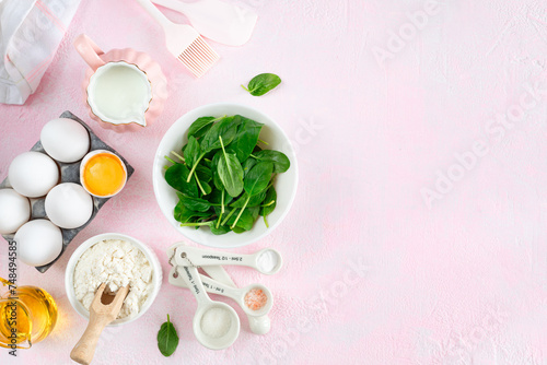 Baking ingredients and kitchen utensils on a pink background, top view