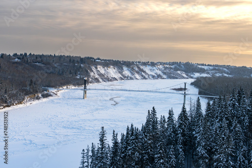 View to Fort Edmonton footbridge in winter season with redish sky