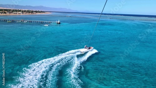 The view from a parasailer to the speedboat on the azure water of the Red Sea. photo