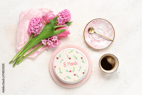Sweet bento cake with cup of coffee and beautiful flowers on white background. International Women's Day