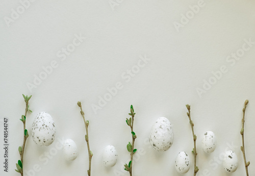 Beautiful Easter eggs and tree branches on white background with space for text