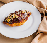 Croissant with chocolate on plate top view