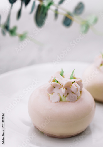 Pink mousse cakes decorated on white plate
