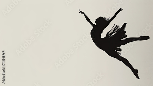 A black and white photograph of a ballerina gracefully performing ballet poses in a studio setting © sommersby