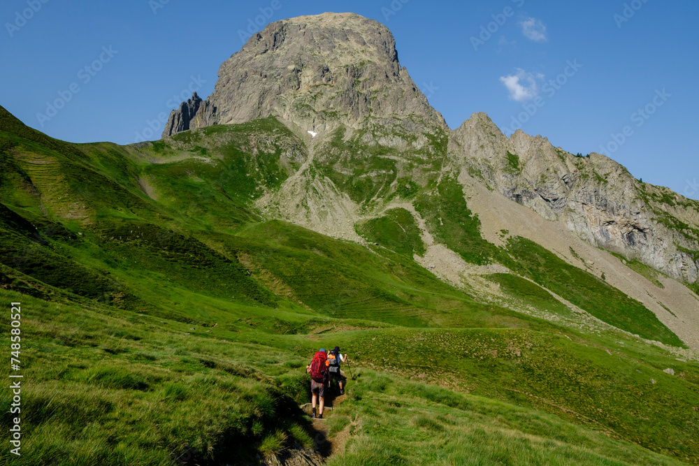 hikers descending into the valley, Col de Souzon, Midi d'Ossau peak, 2884 meters, Pyrenees National Park, Pyrenees Atlantiques, France