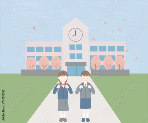 ランドセルを背負って小学校の前に立つ新入生
