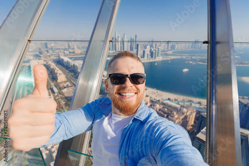 Photography Selfie photo of young crypto businessman smile man tourist on background skyscrapers in Dubai on view point