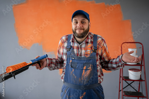 Adult painter man in renovating room with shocked facial expression.