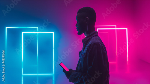 Silhouette of a person holding a smartphone against a vibrant neon lights background. This image is perfect for: tech, urban lifestyle, modern art.