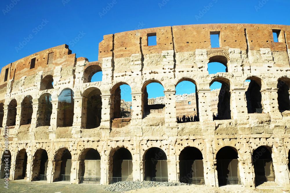 View of Colosseum against a blue sky in Rome, Italy