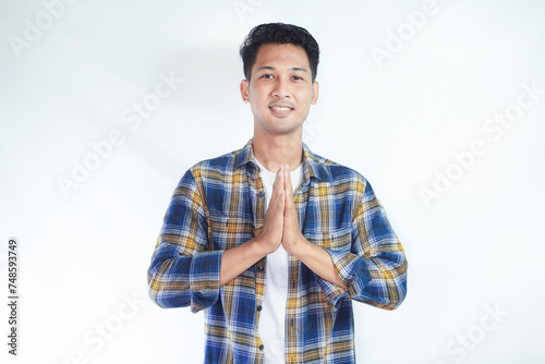 Asian men smiling to the camera while giving warm welcome gesture isolated on white photo