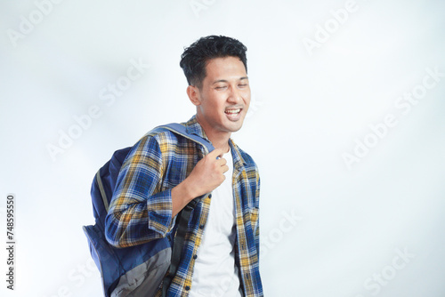 Smiling happy young Asian man student in casual clothes backpack standing confident and ready to school isolated on white background. high school university college concept