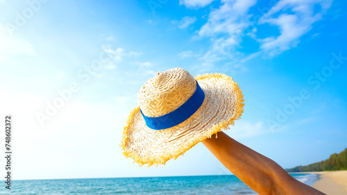 Happy holiday in summer with Sun Hat on the beach as blue sky background