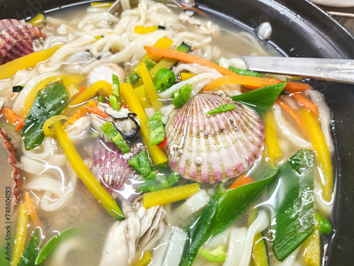 Korean seafood noodles soup. kalguksu (handmade) chopped noodles