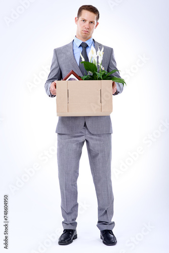 Businessman, suit and box for resignation, fired or transfer at company for liquidation on white backdrop. Employee, worker and sad person for organization loss, fraud and turnover with memorabilia © Duncan M/peopleimages.com