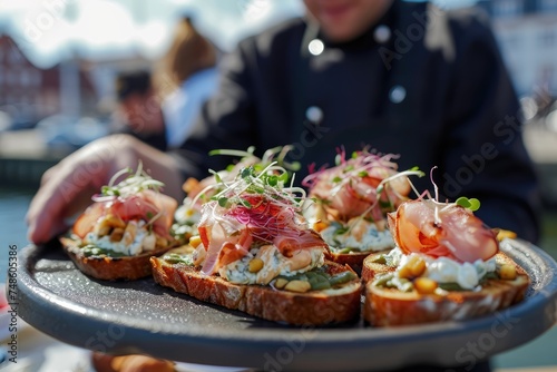 Savoring Tradition: Chef Showcases the Delights of Smørrebrød Against the Picturesque Backdrop of Nyhavn Harbor in Copenhagen.