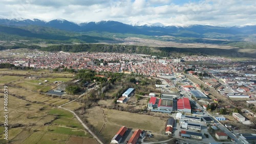 Approaching Bulgarian town Razlog with a drone in late snowless winter . photo