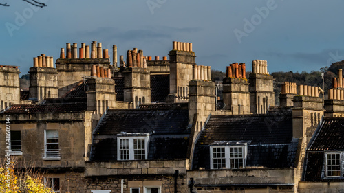 English rooftops adorned with myriad chimneys create a nostalgic vista, embodying the timeless charm and cozy warmth of traditional architecture in just a glance © Eon Nico