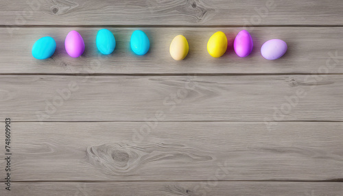 Painted eggs on a wooden table, top view. Abstract background for Easter