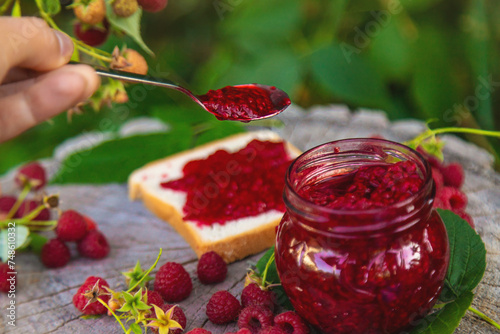 Raspberry jam in the garden. Selective focus.
