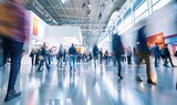 Expo hall at a tech conference with people in motion, blurred effect