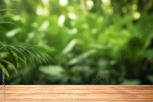 Empty wooden table and tropical forest out of focus in the background.