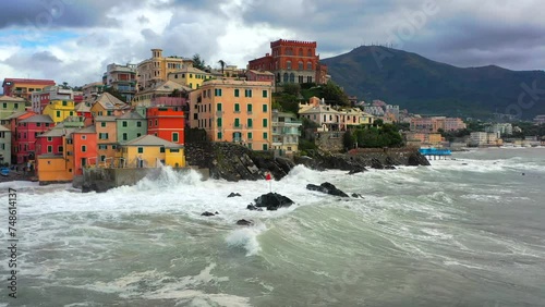 Mare d'inverno, Forte mareggiata sulla costa di Boccadasse a Genova, Liguria, Italia.
Le onde del mare in tempesta si infrangono salla costa ligure. Ripresa aerea dal drone.
 photo