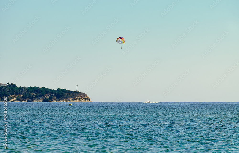 Couple is parasailing in the blue sky. Summer vacation on the Black Sea. Couple is parasailing in the blue sky. Summer vacation on the Black Sea.