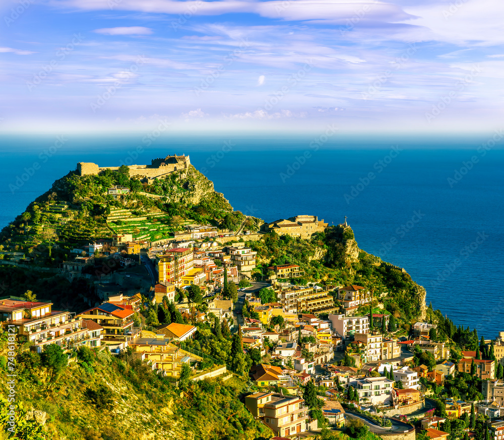 scenic view at beautiful mountain town on a sea coast in Italy with green hills, antique buildings and amazing blue sea on backgeound of landscape