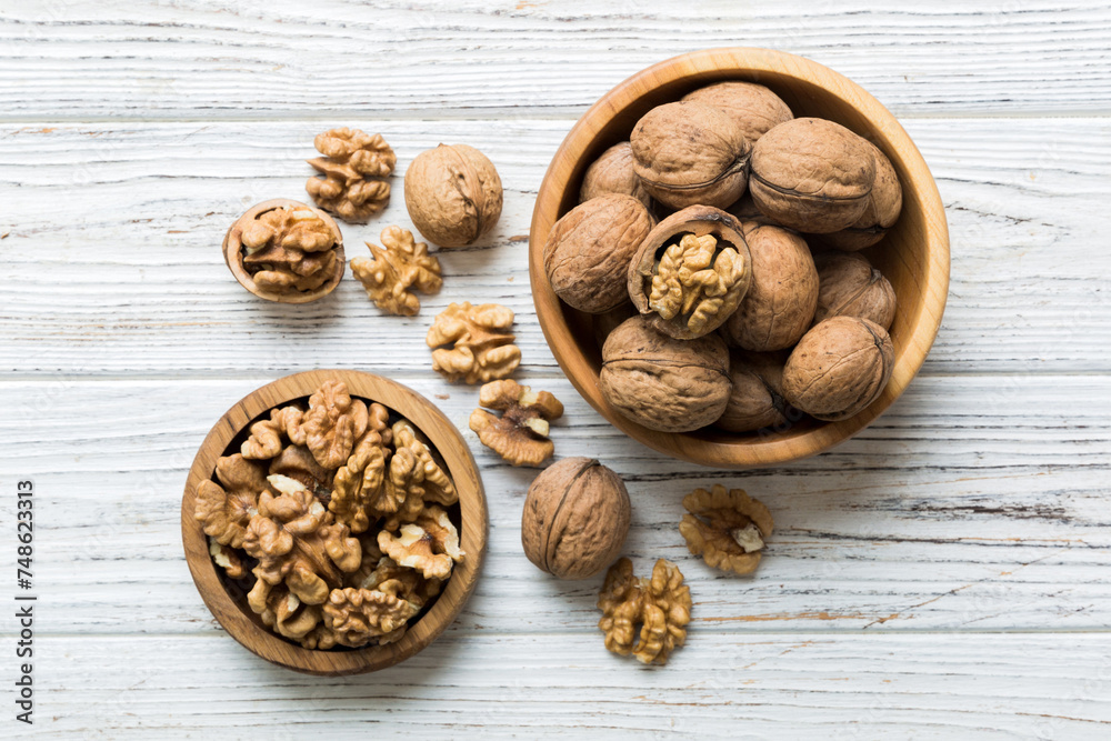 Fresh healthy walnuts in bowl on colored table background. Top view Healthy eating bertholletia concept. Super foods Fresh healthy walnuts in bowl on colored table background. Top view Healthy eating bertholletia concept. Super foods
