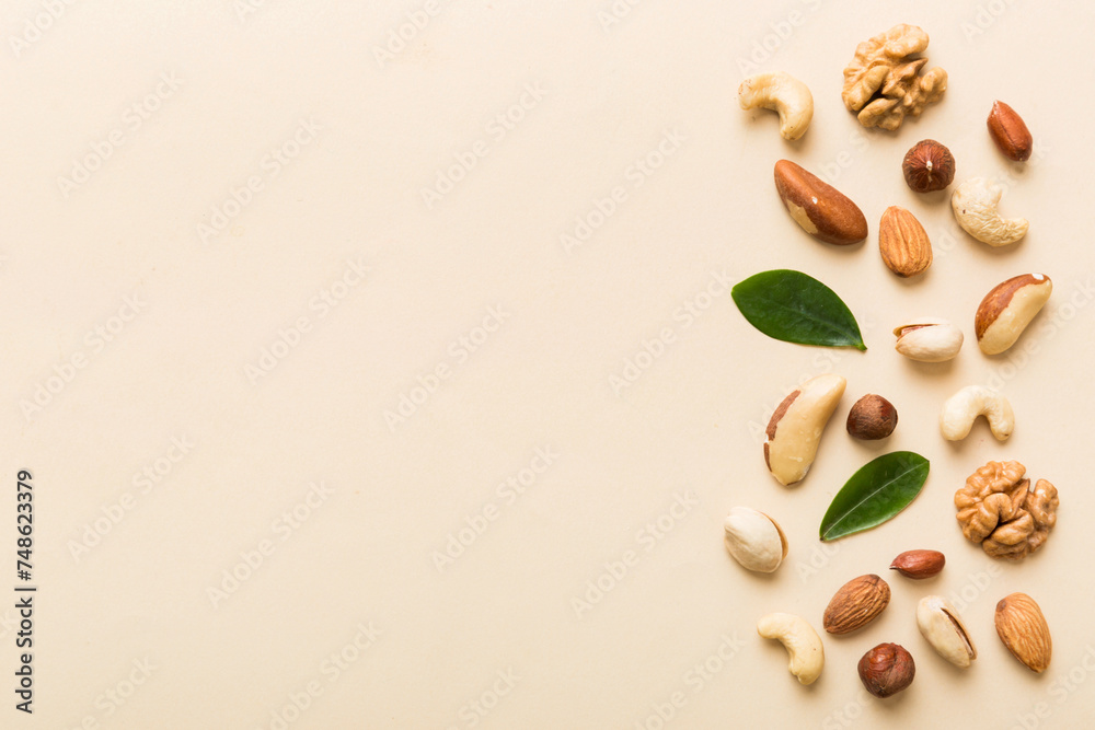 Composition of nuts , flat lay - mix hazelnuts, cashews, almonds on table background. healthy eating concepts and food background Composition of nuts , flat lay - mix hazelnuts, cashews, almonds on table background. healthy eating concepts and food background