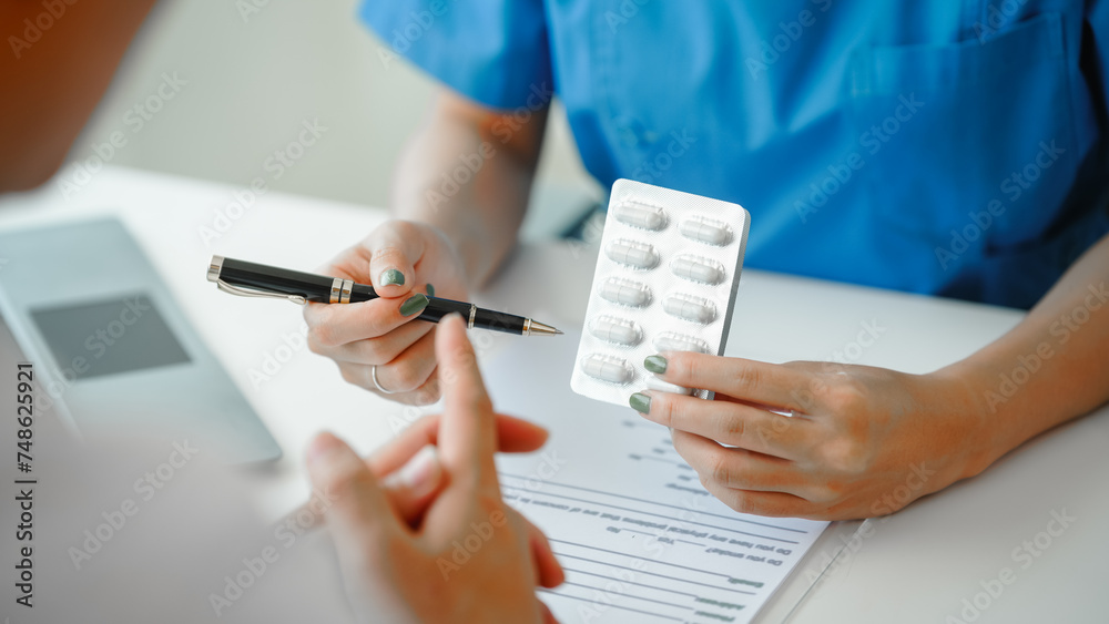 Female doctor provides crucial guidance to male patient in clinic room, discussing heart attack, appointment desk. explanation of capsules, how to use them, and dangers if the dosage is exceeded. - obrazy, fototapety, plakaty 