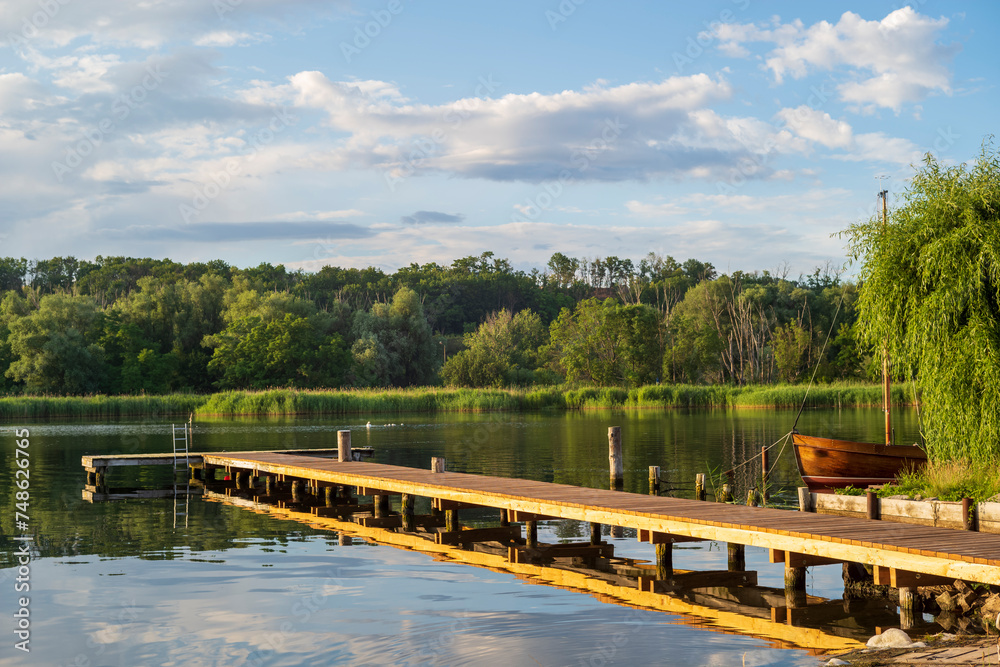 wooden jetty in a lake with a boat wooden jetty in a lake with a boat