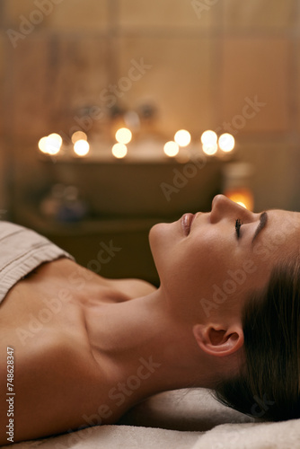 Woman, spa and candle with luxury, calm and peace with wellness and bokeh. Person, skincare and health for zen, relax and body care at resort or massage parlour and serene rest and treatment