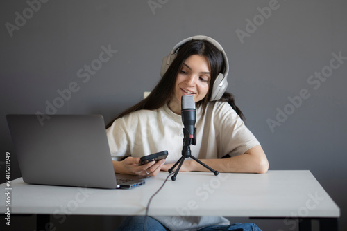 Smiling Woman Engaged in an Online Chat With Microphone and Headphones at Home