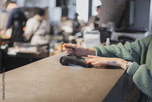 Customer Completing a Credit Card Transaction at a Retail Checkout