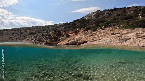Underwater split photo of paradise fjord rocky bay of Tourkopigado  Iraklia island  small Cyclades  Greece