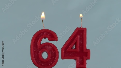 close up on a red number sixty fourth birthday candle on a white background.
 photo
