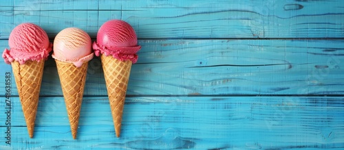 Three tasty sweet ice cream cones over wooden blue background. Generated AI image photo