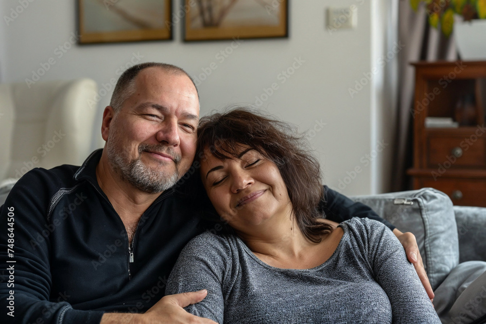 Two adults cuddled up, happy, relaxed in a living room, warm setting. Two adults cuddled up, happy, relaxed in a living room, warm setting.